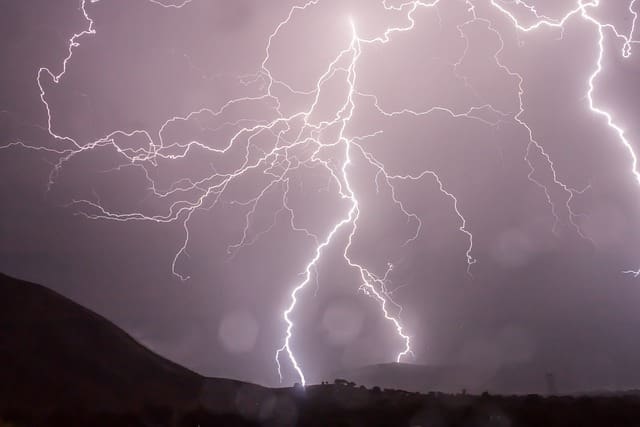 A bunch of lightning bolts are in the sky